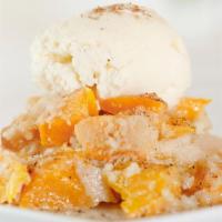 House-Made Peach Cobbler · Served with Vanilla Ice Cream, Caramel Sauce and Powdered Sugar