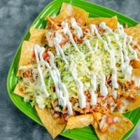 Nachos · Choice of shredded chicken, ground beef, refried pinto beans or cheese.