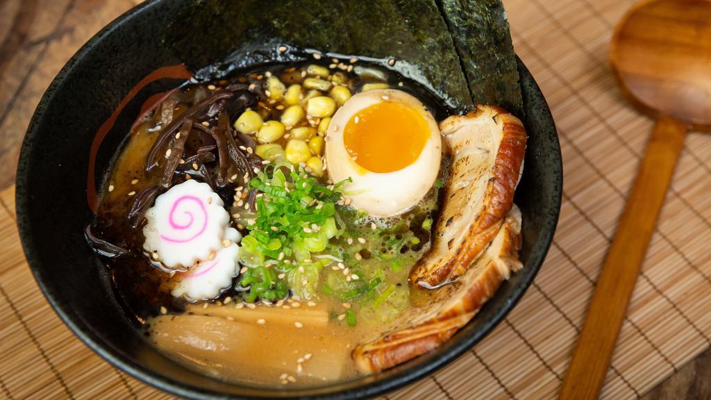Tonkotsu Shoyu Ramen · Skinny noodle with chashu, egg, fish cake, scallion, corn, bamboo shoots, wood ear and nori with pork broth.