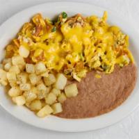 Chilaquiles Plate · Diced corn tortillas, cooked with scramble eggs with jalapeños, tomatoes, onions and topped ...