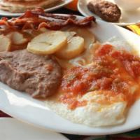 Huevos Rancheros · Two eggs, beans, potatoes and bacon.