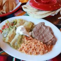 Green Enchiladas · Chicken enchiladas with tomatillo sauce and sour cream, rice, beans and salad.