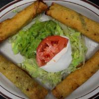 Flautas Mexicanas · Four rolled up and fried corn tortillas, two filled with beef and two with chicken, served w...
