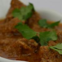 Lamb Curry · Slow cooked chunks of lamb cooked in a special gravy and spices, served with rice, bread and...