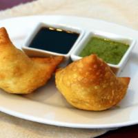 Vegetable Samosa · Two crisp turnovers filled with mild spiced smashed potatoes and green peas.