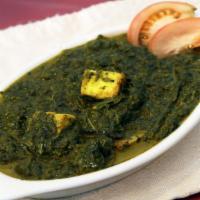Palak Paneer · Minced spinach cooked with the home made cheese and Indian spices. Served with rice.