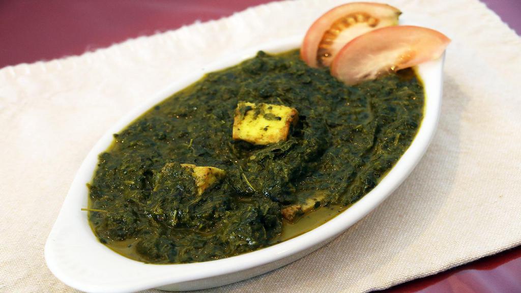 Palak Paneer · Minced spinach cooked with the home made cheese and Indian spices. Served with rice.