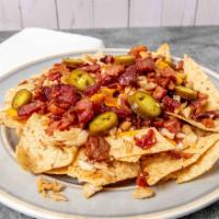 Launched & Loaded Nachos · Cheddar Jack cheese, tomato, onion, jalapeños, sour cream, bacon.