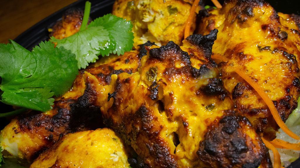 Chicken Tikka · Gluten-free. Skewered pieces of boneless chicken breast marinated in tandoori in tandoori spices, grilled over flaming clay oven.