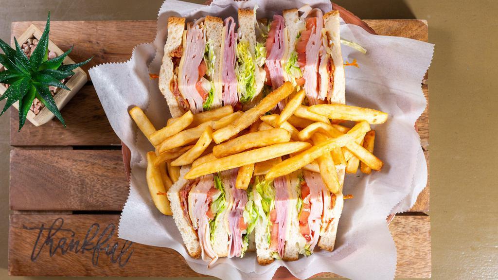 Hop-Deli Club · Turkey, ham, Swiss, bacon. Topped with mayo, tomatoes, and lettuce.