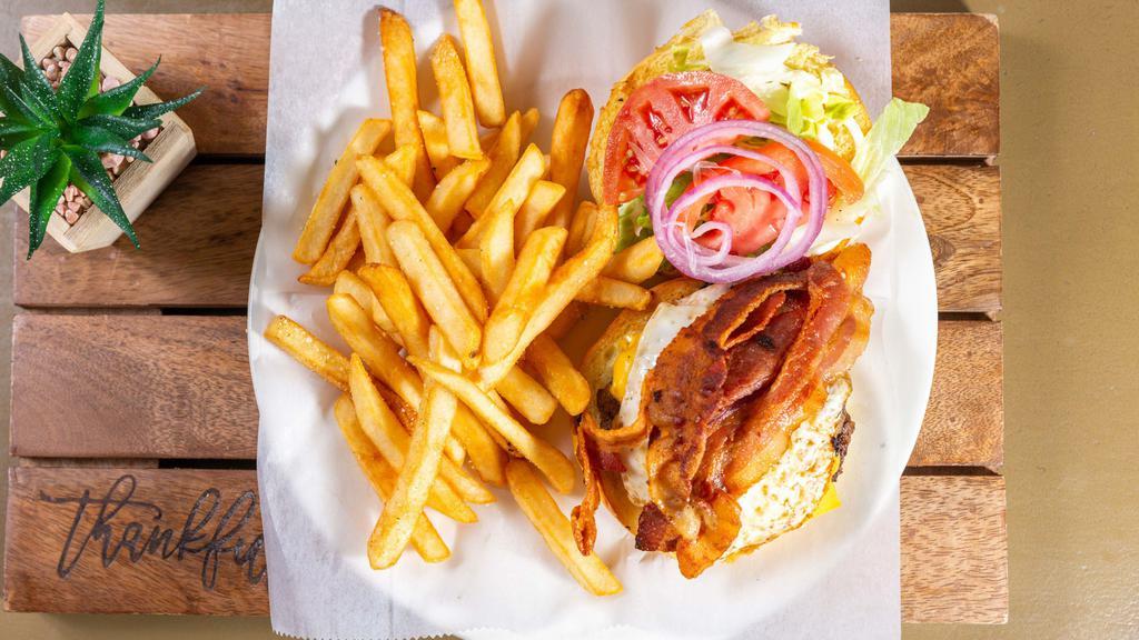 The Hangover Burger · 1/2lb patty, bacon, fried egg, American cheese, mayo, lettuce, tomato.