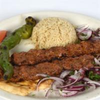 Lamb Adana Kebab · 2 Skewer of char-grilled chopped lamb kebab served with turkish lavash bread, rice pilaf, ve...