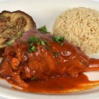 Lamb Shank · Tender lamb shank baked with tomato sauce served with eggplant and rice pilaf.