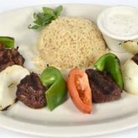 Lamb Shish Kebab · Gluten free. Marinated skewered tender lamb cubes served with rice pilaf and vegetables. Con...
