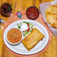 Chimichanga · Ground beef, chicken or pork wrapped in a flour tortilla with refried beans and cheese. Frie...