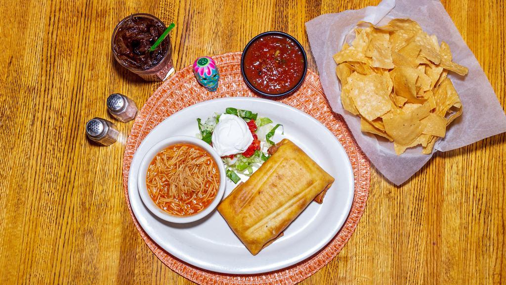 Chimichanga · Ground beef, chicken or pork wrapped in a flour tortilla with refried beans and cheese. Fried golden brown and served with sour cream.
