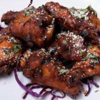 Firebird Wings · Shares & Sides | Grilled chicken wings tossed in our wing sauce topped with cotija & cilantr...
