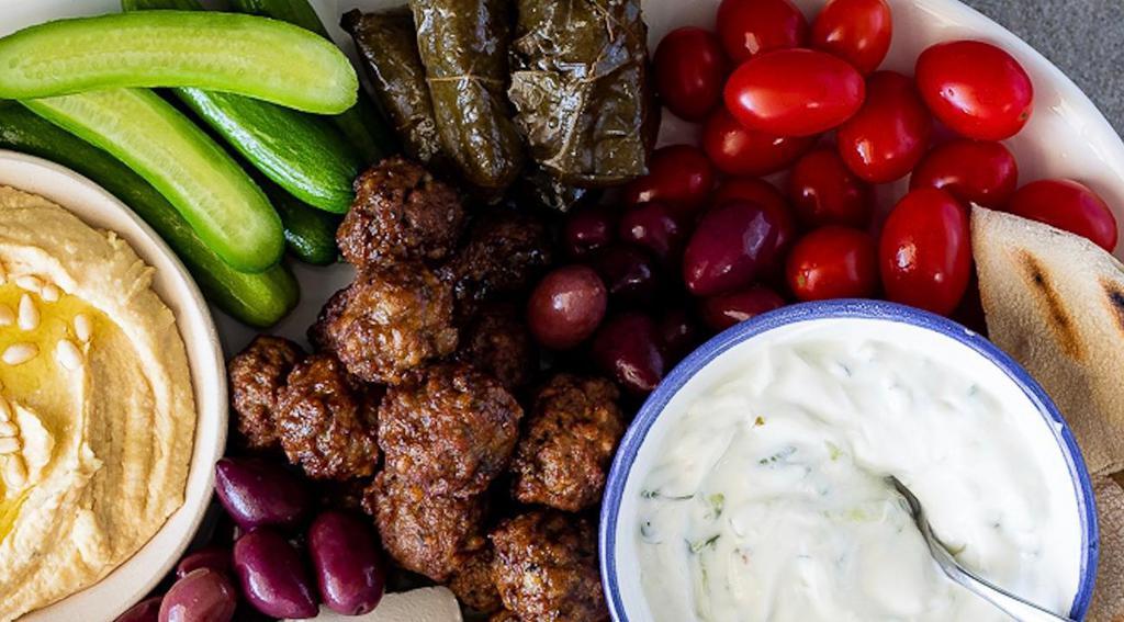 Messa Platter · Ideal for sharing! Stuffed grape leaves, Kalamata olives, homemade tzatziki sauce, grilled sausage, gyro meat & grilled Pita bread