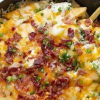 Texas Fries · Crispy fries topped with bacon, ranch dressing & melted cheese.