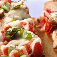 Bruschetta · Italian bread seasoned with extra virgin olive oil and fresh herbs, topped with roma tomatoe...