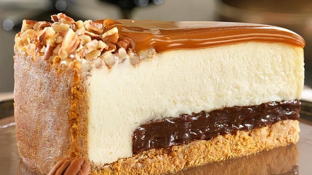 Gourmet New York Turtle Cheesecake · New York Style Turtle Cheesecake, every slice is Heaven, beginning with a thick layer of fudge, covered with caramel sauce, garnished with chopped pecans, all wrapped up in a graham cracker crust.