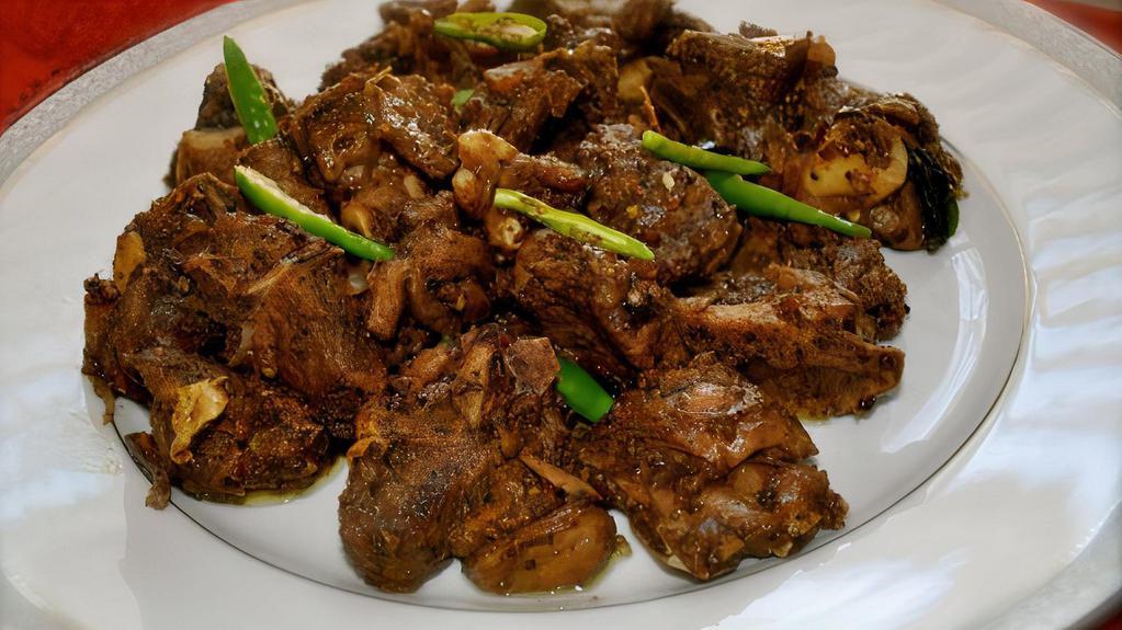 Kerala Coconut Lamb · Peppered lamb cubes sauteed with coconut flakes, onions, spices and finished with curry leaves.