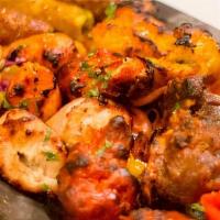 Tandoori Platter · A sampler of chicken tikka, malai kabab, lamb, kabab, chicken wings, and herbed tandoori shr...