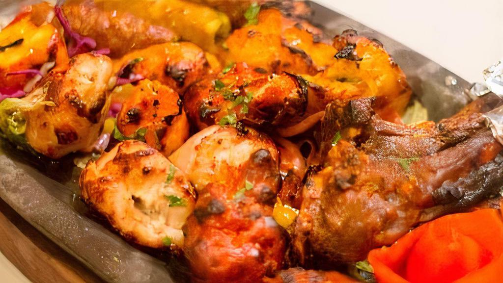 Tandoori Platter · A sampler of chicken tikka, malai kabab, lamb, kabab, chicken wings, and herbed tandoori shrimp, served with rice, yellow lentils, and freshly baked tandoori naan.