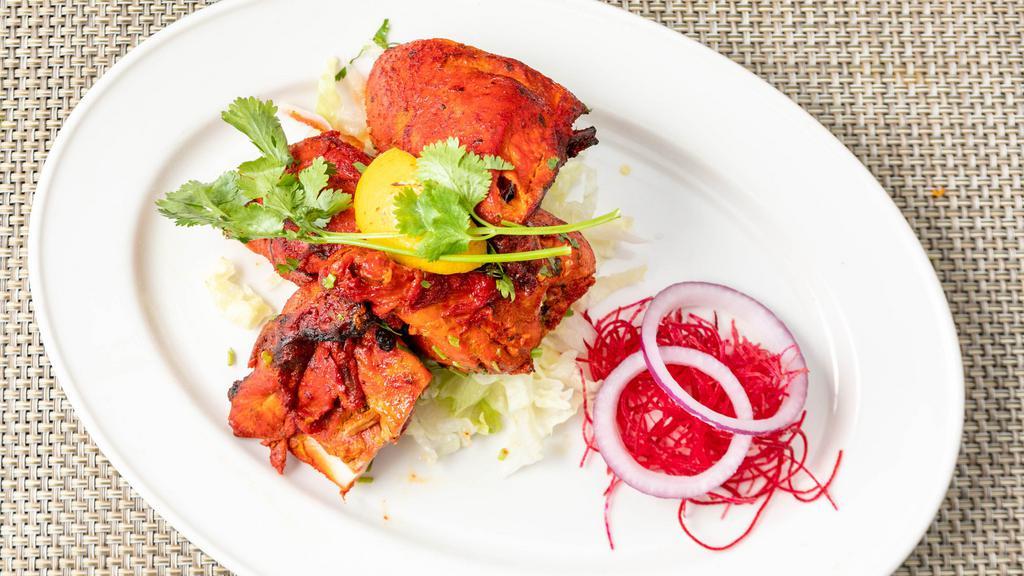 Chicken Tandoori · Half spring chicken marinated in yogurt, garlic, spices, and lemon juice; roasted on skewers in a clay oven. Marinated classics cooked in a traditional clay oven or grilled to perfection, choice served with rice and yellow lentils.