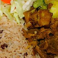 Curry Goat · Served with rice and peas, or white rice.