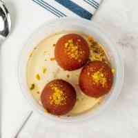 Gulab Jamun · Dumplings made of milk solids are deep-fried and soaked in a rosewater.