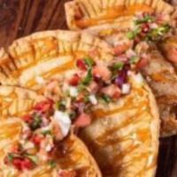 Empanadas · 3 empanadas with choice of protein: chicken, cheese or beef, topped with pico de gallo and p...