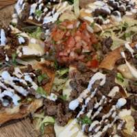 Nachos · Fried tortilla with a special of pinto beans, melted cheese and a drizzle of sour cream topp...