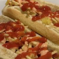 Colombian Hotdog · Hot dog topped with bacon, ham, cheese, pineapple, crushed potato chips, pink sauce and ketc...