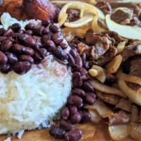 Bistec Encebollado · Grilled steak with sautéed onions, side of rice, beans and maduro.