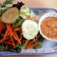 House Salad · Lettuce, onion, carrot, tomato, cucumber, and peanut sauce dressing.