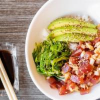 Tuna Poke · Hawaiian style marinated Tuna, diced Onion, Avocado, Seaweed salad served over sushi rice.