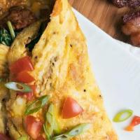 Houston Omelette  · Sautéed spinach, Mexican chorizo, and fresh tomatoes topped with melted cheese. Served with ...