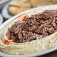 Hummus Deluxe Plate · Large Hummus plate, topped with choice of shawarma, gyro, or kebabs along with onions, pickl...