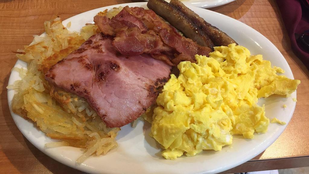Cadillac Breakfast Special · Cadillac square specialty. 3 extra large eggs fried in butter, 2 rashers of bacon, 2 sausage links, 1 slice of ham, hash browns or grits or pancakes and toast and jelly.