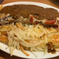 Mexican Omelette · Served with spiced ground beef, onions, green peppers, tomatoes and cheddar cheese, topped w...