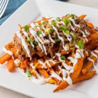 Pulled Pork Fries · Smoked moist brisket over fries with shredded cheese blend,  BBQ sauce, and garnished with s...