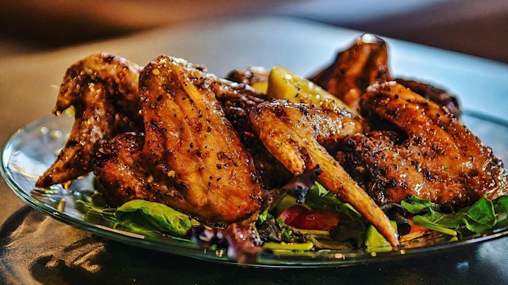 Henny Wings · Four whole Chicken wings deep-fried and tossed in our signature Hennessey sauce, served with fresh cut fries.