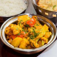 Aloo Gobi · New. Potatoes and cauliflower, tossed with tomatoes mildy spiced.