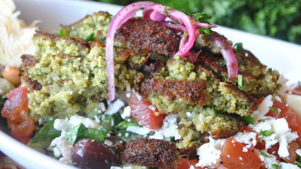 Falafel Salad · Enhance nutrition and taste with our popular Greek feta salad garnished with falafel crumbles, it’s a winner!