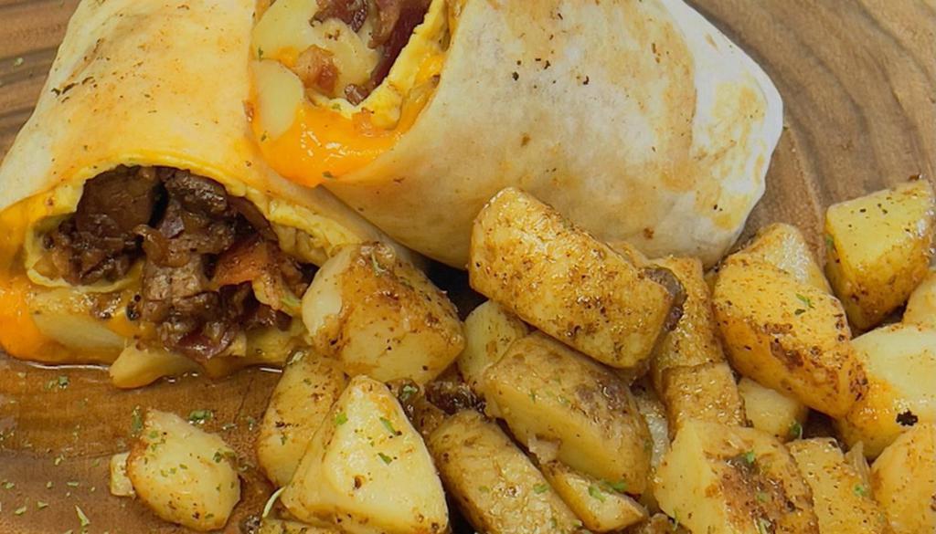 All American Burrito · Two scrambled eggs, cheddar cheese, carne asada, bacon, breakfast potatoes and chipotle mayo in a flour tortilla