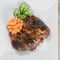 Jerk Chicken · Served with your choice of white rice, yellow rice or rice and peas, cabbage and plantains.