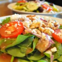 Spinach Salad (Whole) · Organic spinach, tomatoes, red onions, toasted walnuts & goat cheese, served with our raspbe...