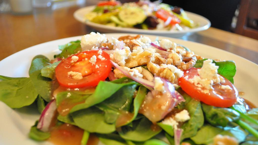 Spinach Salad (Whole) · Organic spinach, tomatoes, red onions, toasted walnuts & goat cheese, served with our raspberry balsamic vinaigrette.