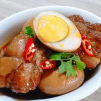 #39. Com Thit Kho Tau · Pork bellies and eggs braised in coconut juice and soy sauce, served with white rice.